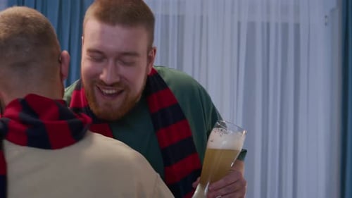 Friends Gather Indoors With Beer and Scarves