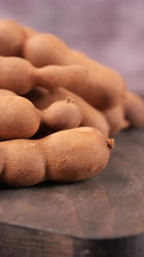Tamrindenfrucht zeigt Textur und Farbe auf der Holzoberfläche