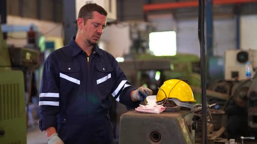 Industrial factory employee working in metal manufacturing industry