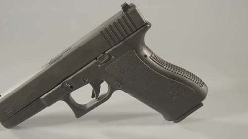 Über eine 9-mm-Pistole schwenken vor weißem Hintergrund