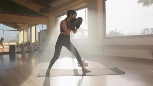 Young Woman Practicing Punches in a Fitness Studio