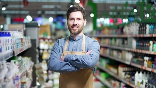 Portrait man worker in supermarket grocery store or deli in apron look at camera Male sales manager