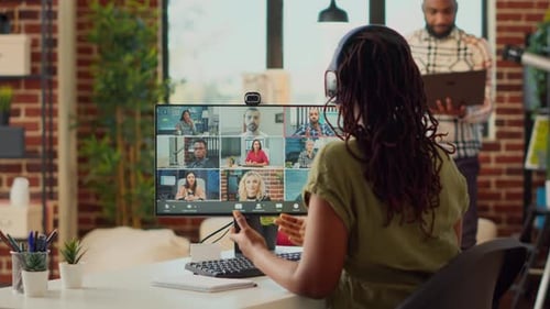 Businesswoman Attends Virtual Meeting from Home Office