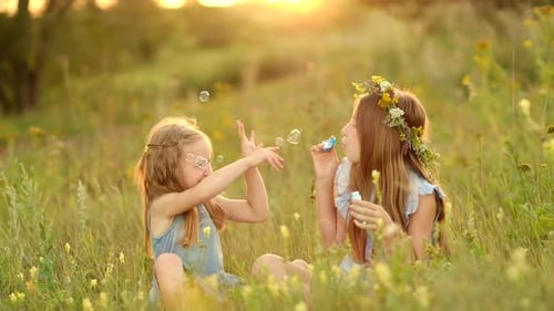 Litlte Girls Blowing Bubbles
