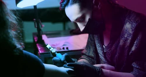 Milan/Italy-01.02.2019:Slow motion of professional master of the art of tattooing doing a tattoo t