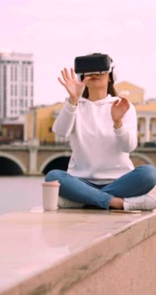 Vertical Shot of a Young Woman Meditating in Vr Glasses in the Midst of a Bustling City