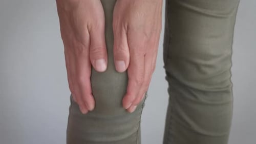 Close Up of Adult Massaging Their Knee
