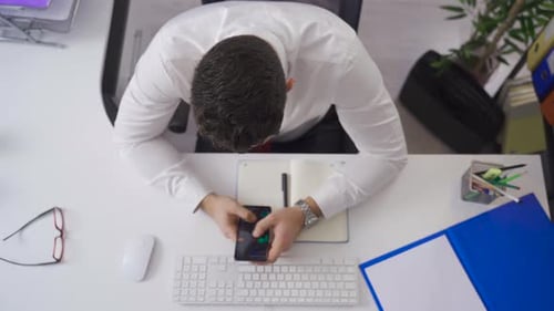 Stock trader businessman analyzing charts on his phone. Cryptocurrency and investment.