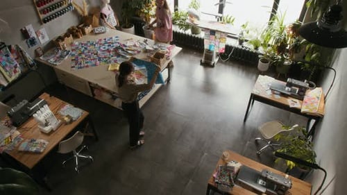 Top view of Two Seamstresses Working on New Garments in Workshop