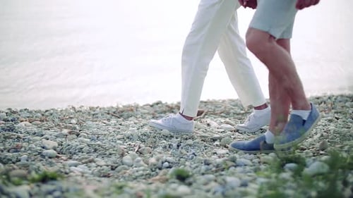 Midsection of Senior Couple on a Holiday on a Walk by The