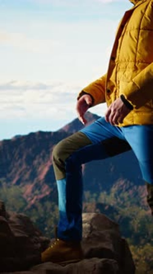 Vertical Video Proud Explorer Basks in the Joy of Accomplishment Standing at the Mountain Peak