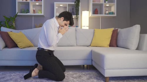 The man who is alone at home is exhausted and disappointed.