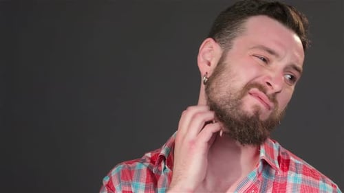Young Guy Scratches His Beard
