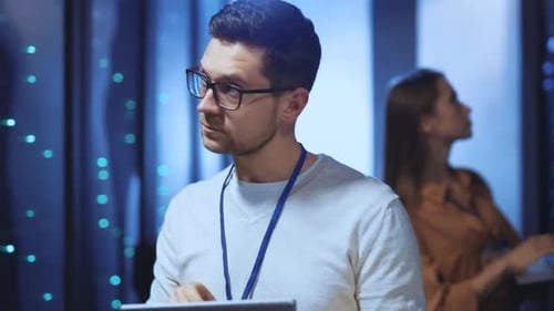 Data Center Engineers Working With Tablets and Computers