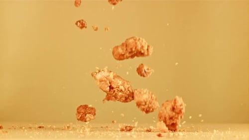 Crispy Fried Chicken Pieces Falling in Slow Motion