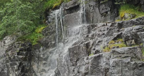 Scenic Waterfall Cascading Down a Rocky Mountain in Norway