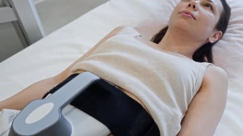 Woman Receiving Electromagnetic Body Contouring Treatment
