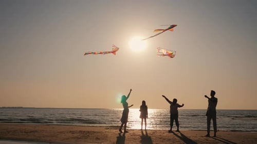 Funny Family Plays Together on the Beach Let Kites Into the Sky
