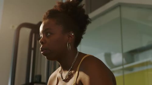 Plus Size Black Woman Doing Standing Cable Crossover Press at Gym
