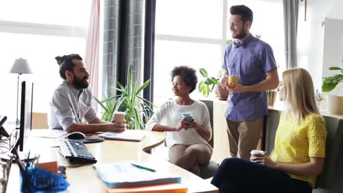 Creative Professionals in Office Meeting with Coffee