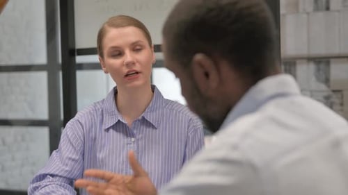 Close up of Creative Woman Talking with Male Colleague