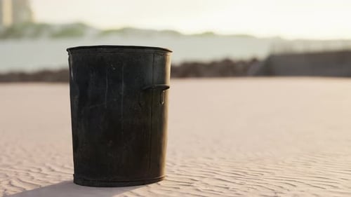 Gray Metal Garbage Bin or Trash Can on the Beach