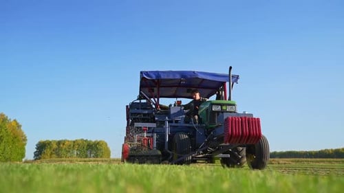Tractor harvesting crops in a rural field