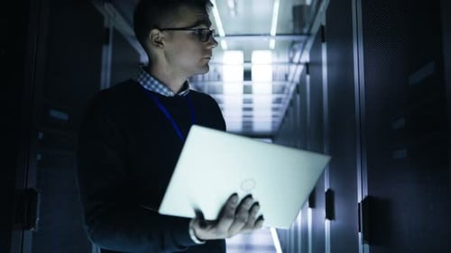 Young Adult Working on Laptop in Data Center
