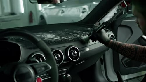 Man Cleaning Car Interior with Detailing Brush