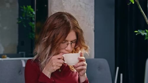 Relaxed Smiling Satisfied Woman with Red Cup of Coffee Standing on the Street End Enjoying a Sunny