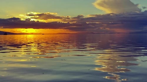 Clouds And Calm Water At Yellow Sunset On Ocean Island Beach