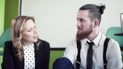A Group of Business People Sitting on the Floor in an Office,