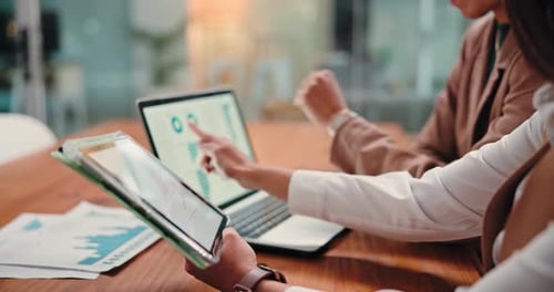 Adults Analyzing Data Together in Modern Office