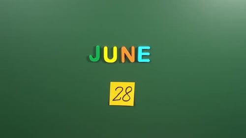 Hand sticking a sticker 28 June calendar day on school board. 28 date of June. Twenty eighth day