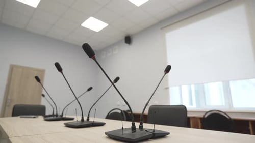 Close View of Microphones on Table in Meeting Room Setup
