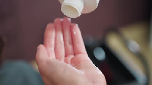 Lotion Poured Onto Hand in Close Up