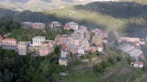 Aerial view of a little village through the mountains in Italy