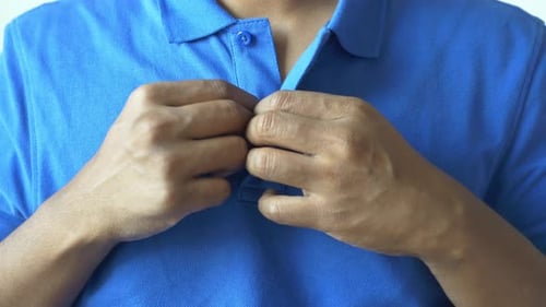 Man Buttoning His Shirt Close Up