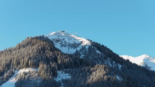 Static Aerial Perspective of Sunny Winter Morning with Snowy Mountain and Chairlift in the Austrian