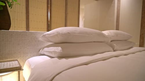 white pillows decoration on bed in luxury hotel resort bedroom