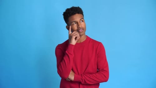 Cheerful Black Man with Pensive Gesture