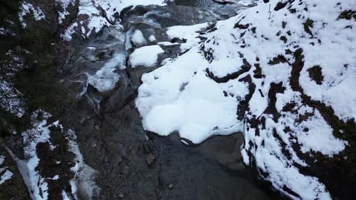 View of a waterfall during winter. Cold and frost in the forest