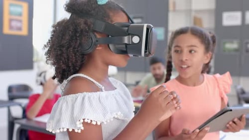Biracial girls explore virtual reality in a classroom at school