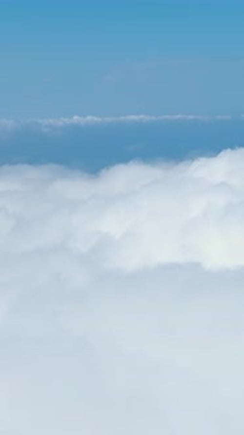 Vertical Video Blue Sky and White Clouds Hover Over Green Forests in a Stunning High Mountain