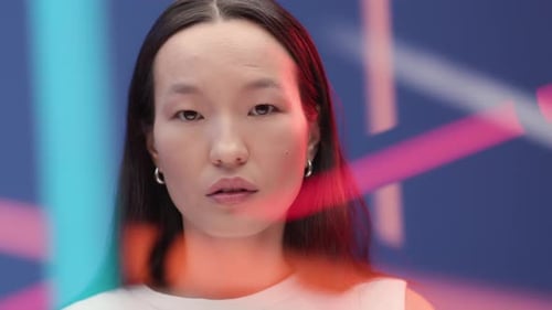 Abstract Portrait Of Young Asian Woman In Vibrant Colorful Light Of Bright Neon Lines. Female Per...