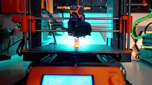 3D Printer in Operation Printing Orange Object