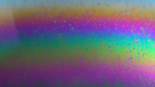 Rotating abstract multicolor soap bubble texture. Slow motion. Planet in science fiction.