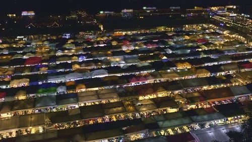 Panning Over Colorful Asian Market Tents and Food Stalls at Night
