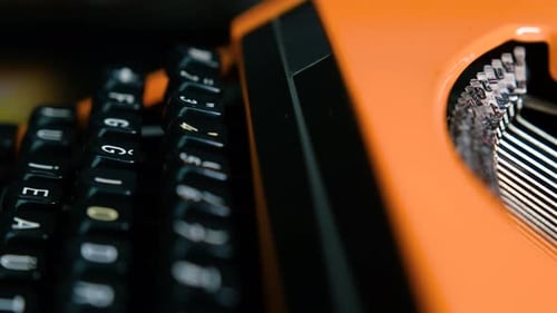Writing letters with orange retro vintage typewriter