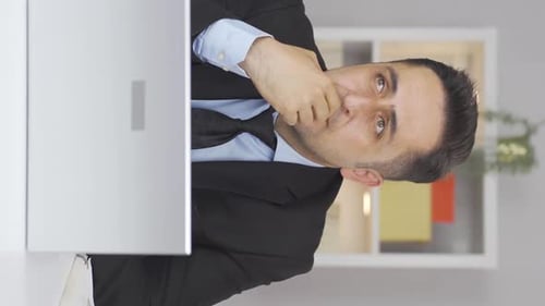 Vertical video of Home office worker man thinking depressed.
